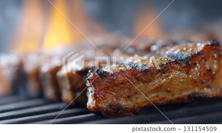 Grilled meat sizzling on barbecue grill with flames, showcasing the return of meat consumption 131154509