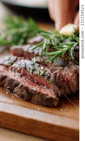 Juicy grilled steak garnished with fresh herbs on a wooden cutting board showcasing meat is back 131154521