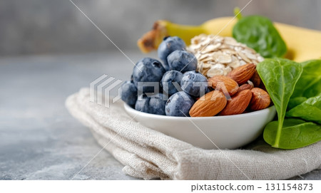 A colorful mix of fiber-rich foods: oats, blueberries, almonds, and spinach for a nutritious meal 131154873