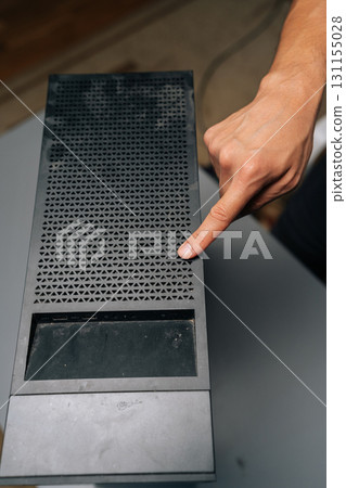 Top view of computer technician checking dust accumulation on desktop case, preventing potential overheating and maintaining system performance with careful cleaning process. Concept of service PC. Top view of computer technician checking dust accumulation on desktop case, preventing potential overheating and maintaining system performance with careful cleaning process. Concept of service PC. 131155028