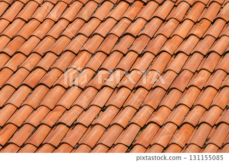 Macro view of orange red terracotta tiles laid in tight, overlapping rows Macro view of orange red terracotta tiles laid in tight, overlapping rows 131155085