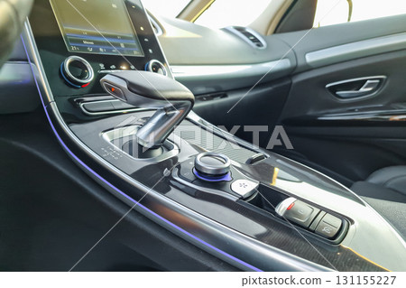 Luxury car interior showcases modern technology and elegant design in a sleek cabin setting with sunlight pouring through Luxury car interior showcases modern technology and elegant design in a sleek cabin setting with sunlight pouring through 131155227