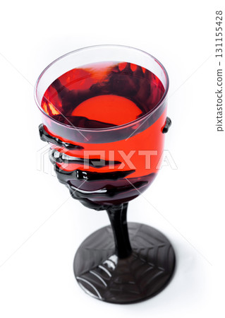 Halloween spooky red cocktail in skeleton hand glass Halloween spooky red cocktail in skeleton hand glass 131155428
