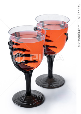 Halloween spooky red cocktail in skeleton hand glass Halloween spooky red cocktail in skeleton hand glass 131155430