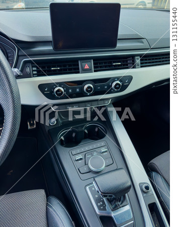 Modern car interior showcases sleek design and advanced technology in a luxury vehicle parked under bright daylight 131155440