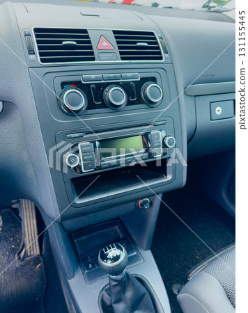 Dashboard view of a compact car interior with essential controls in natural light during daytime Dashboard view of a compact car interior with essential controls in natural light during daytime 131155445
