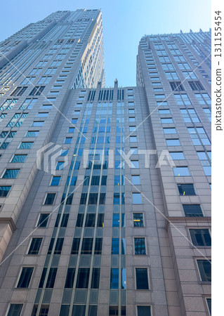 Soaring skyscrapers reflect sunlight in a bustling cityscape on a clear day, showcasing modern architecture and urban life Soaring skyscrapers reflect sunlight in a bustling cityscape on a clear day, showcasing modern architecture and urban life 131155454