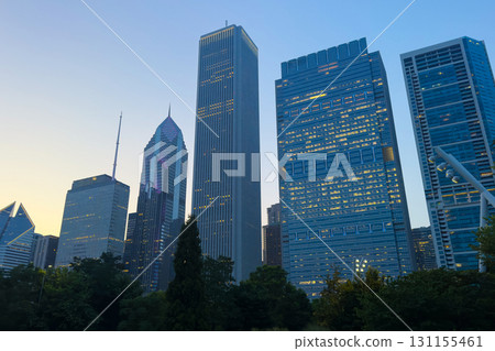 Majestic skyline reveals the vibrant architecture of a bustling city just before dusk in an urban oasis filled with greenery Majestic skyline reveals the vibrant architecture of a bustling city just before dusk in an urban oasis filled with greenery 131155461