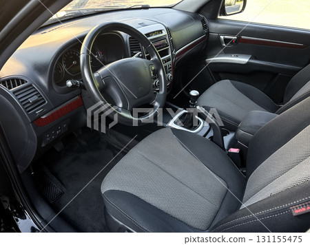 Elegant interior of a modern sedan showcasing sleek design, comfortable seating, and stylish dashboard details in bright sunlight 131155475