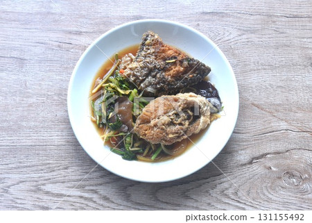 spicy deep fried chop Nile Tilapia or mango fish slice ginger and ear mushroom couple celery dressing soy sauce on plate spicy deep fried chop Nile Tilapia or mango fish slice ginger and ear mushroom couple celery dressing soy sauce on plate 131155492