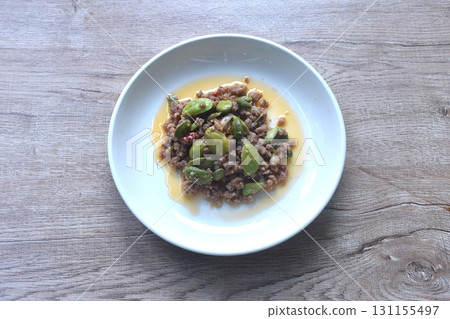spicy fried chop pork with flat bean in shrimp paste curry Thai southern food on plate   131155497