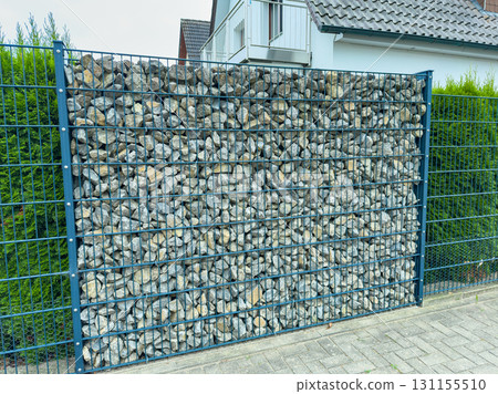 Creative rock wall design enhances outdoor space and provides privacy in a contemporary home setting Creative rock wall design enhances outdoor space and provides privacy in a contemporary home setting 131155510