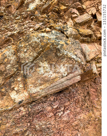 Nature's vibrant layers captured in a rugged rock formation displaying rich textures and colors in a natural landscape Nature's vibrant layers captured in a rugged rock formation displaying rich textures and colors in a natural landscape 131155732