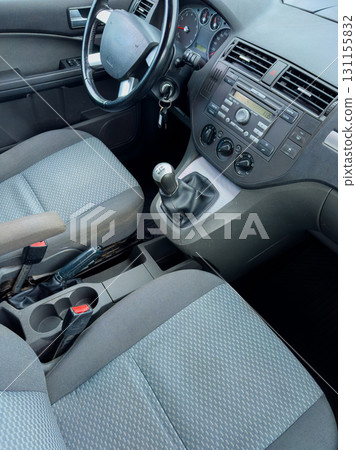 Interior view of a modern vehicle showcasing seats, gear shift, and dashboard in a contemporary design setting 131155832