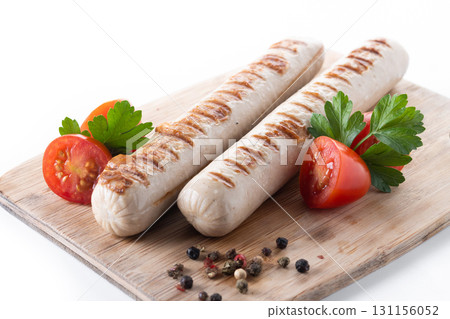 Grilled white sausages with cherry tomatoes and parsley Grilled white sausages with cherry tomatoes and parsley 131156052