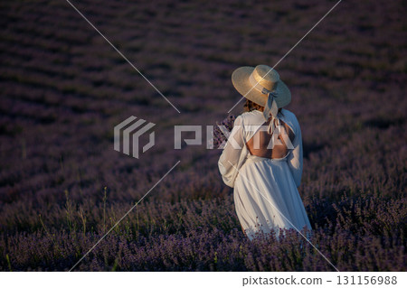Lavender Field Woman Dress: Sunset Provence France, summer, photography; woman admires scenic purple blossoms. 131156988