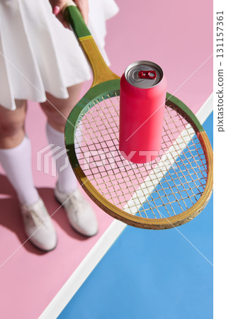 Tennis player holding vintage racket with red copy space beverage can on strings, Tennis player holding vintage racket with red copy space beverage can on strings, 131157361