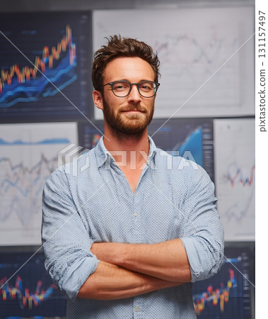confident trader with crossed arms in front of upward charts 131157497