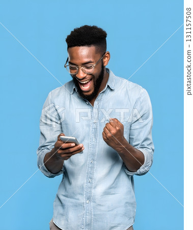 young man excited after checking profit on smartphone 131157508