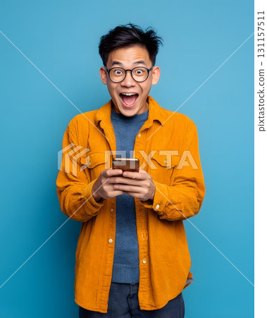 young man excited after checking profit on smartphone 131157511