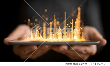 hands holding transparent tablet with glowing investment data 131157520