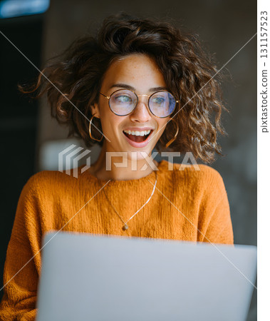 cheerful woman using laptop with clear profit report 131157523
