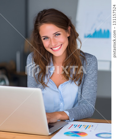 cheerful woman using laptop with clear profit report 131157524