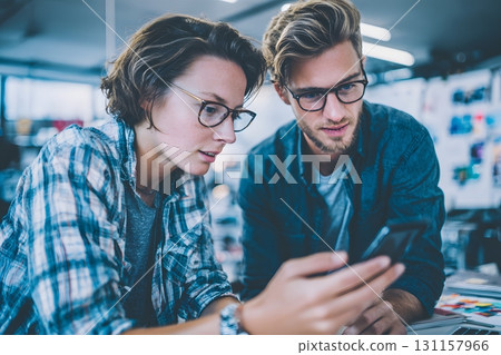 entrepreneurs developing mobile app prototype together 131157966
