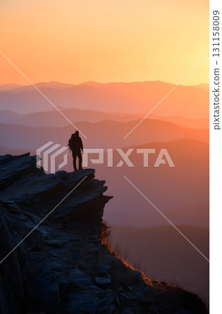 Silhouette of mountain hiker enjoying sunrise symbolizing resilience 131158009