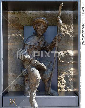 Statue of pilgrims to Santiago de Compostela by Sieger Koder in front of Church of Saint Bartholomew in Leutershausen, Germany 131158916