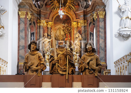 Statues of thre Martyrs Kilian, Colman and Totnan, Neumunster Collegiate Church in Wurzburg, Germany 131158924