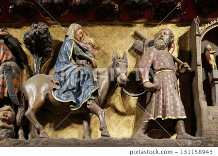Flight into Egypt, carved and painted frieze inside Notre Dame Cathedral in Paris, France 131158943