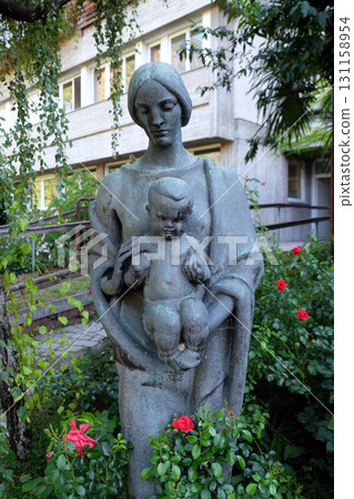 Virgin Mary with baby Jesus statue in the garden of the Blind Center Saint Raphael in Bolzano, Italy 131158954