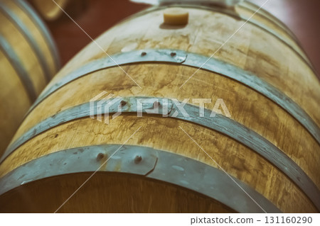 oak barrel with iron hoops for storing wine and sherry close-up oak barrel with iron hoops for storing wine and sherry close-up 131160290