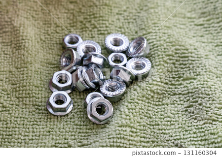 locknut hex pile on green background for threaded connection 131160304