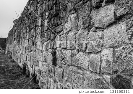 fortress wall made of stones in gray tones, toning 131160311