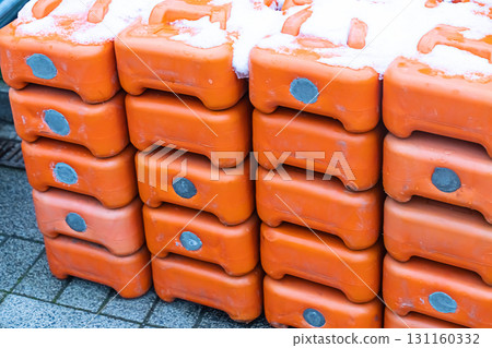 wall of plastic gasoline cans orange stacked in a row covered with snow wall of plastic gasoline cans orange stacked in a row covered with snow 131160332