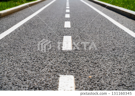 white lines on the asphalt close-up, road markings breaking line 131160345