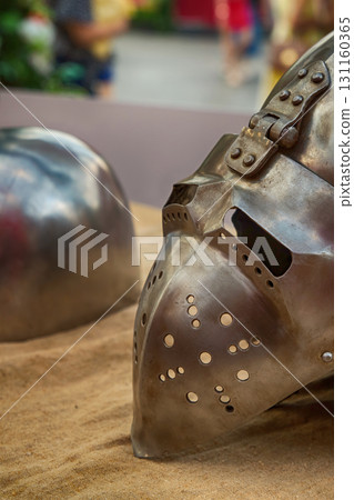 iron helmet with a folding visor close-up, part of the ammunition of a medieval warrior 131160365