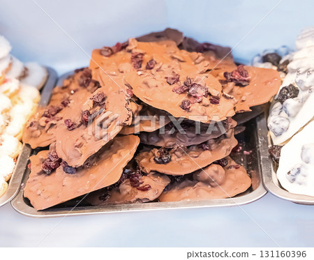 dark chocolate with dried cranberries, handmade sweets close up 131160396