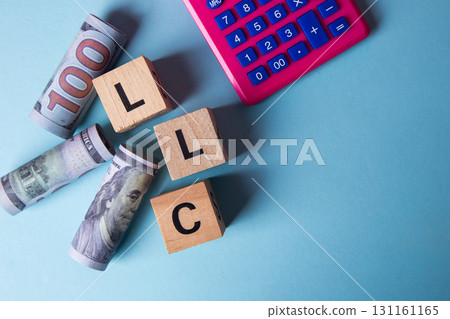Llc abbreviation with money and calculator for business finance 131161165