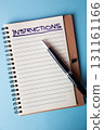 Instructions written on a lined notebook page with a black pen on a blue background 131161166