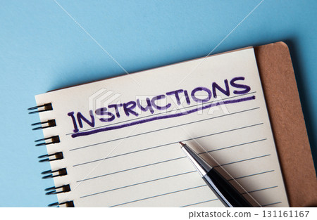 Writing instructions in a notebook for learning and planning 131161167