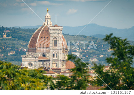 The Duomo of Florence, Italy, stands tall against a backdrop of rolling hills.. 131161197