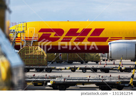 Schkeuditz, Germany - 23th August, 2025 - Many big cargo planes parked on Leipzig Halle airport terminal tarmac apron for loading, service maintenance. DHL air mail express fast logistic hub terminal 131161254