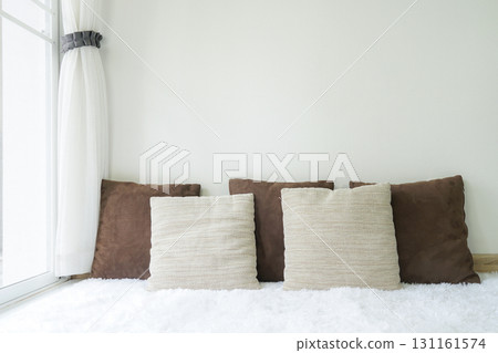 Empty white walls in the living room next to a window with lots of natural light. 131161574