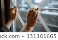 Cross tape repair on indoor window glass, rainy day, daytime 131161665