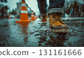 A man's feet stepping through a puddle on a rainy day in the city 131161666