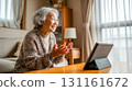 Elderly woman relaxing during the day using a tablet indoors 131161672