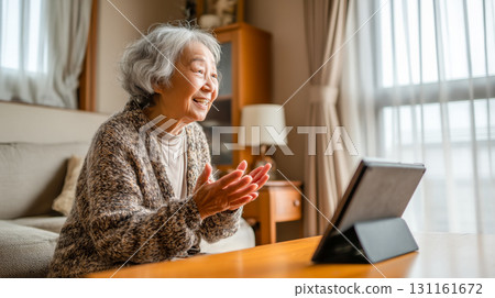 Elderly woman relaxing during the day using a tablet indoors 131161672